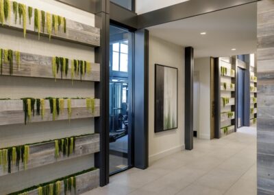 A hallway with plants on shelves.